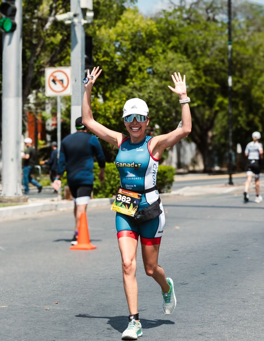 A woman running in an outdoor event.
