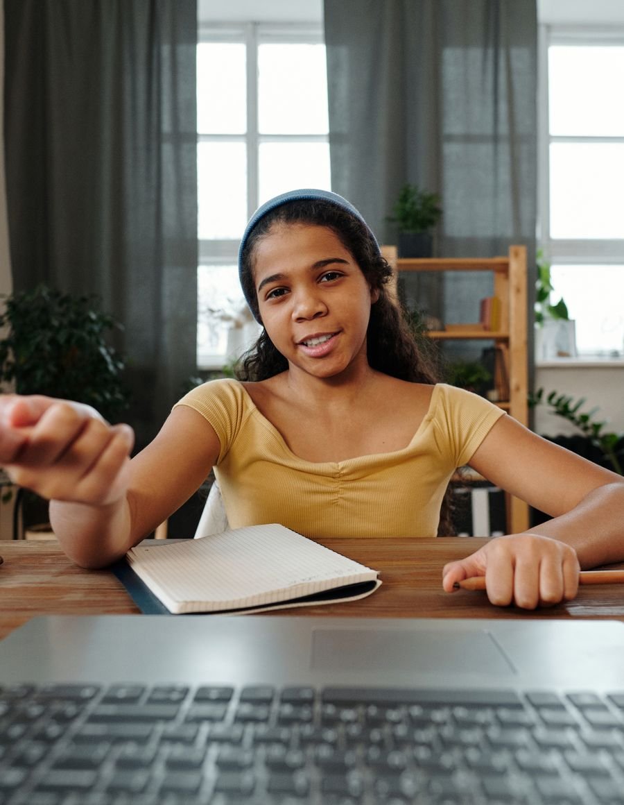 A woman working at a laptop.