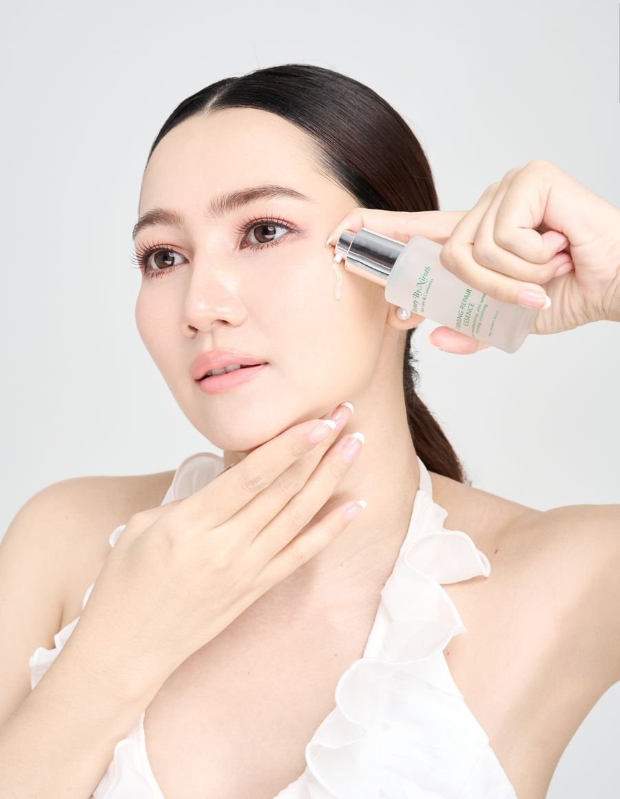 A woman applying facial skincare.