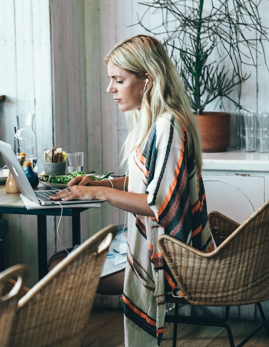 A woman working at a laptop.
