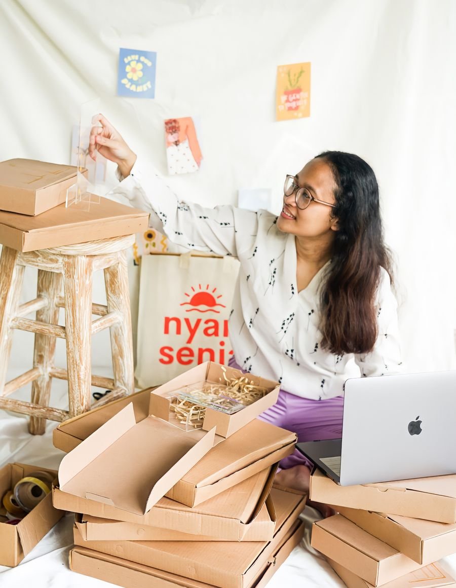 A woman packing orders.