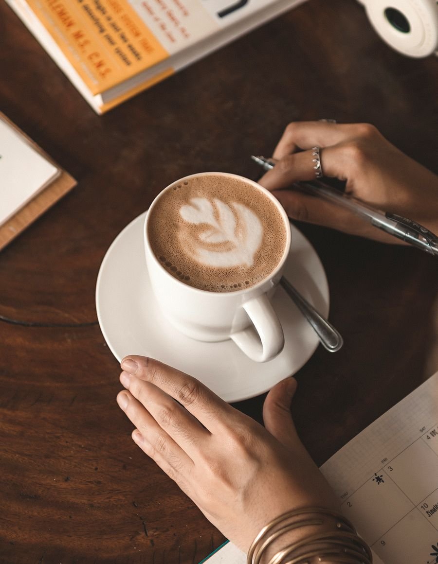 A woman enjoying coffee at a cafe.