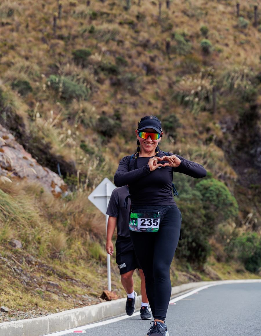 A woman running on a mountain road.